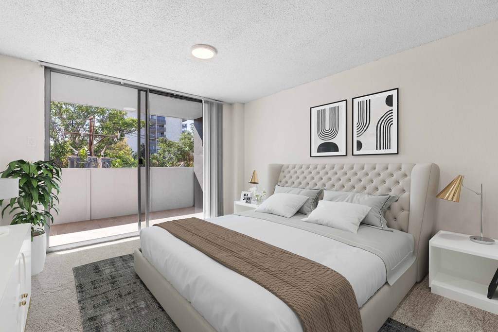 a bedroom with a bed and a large window