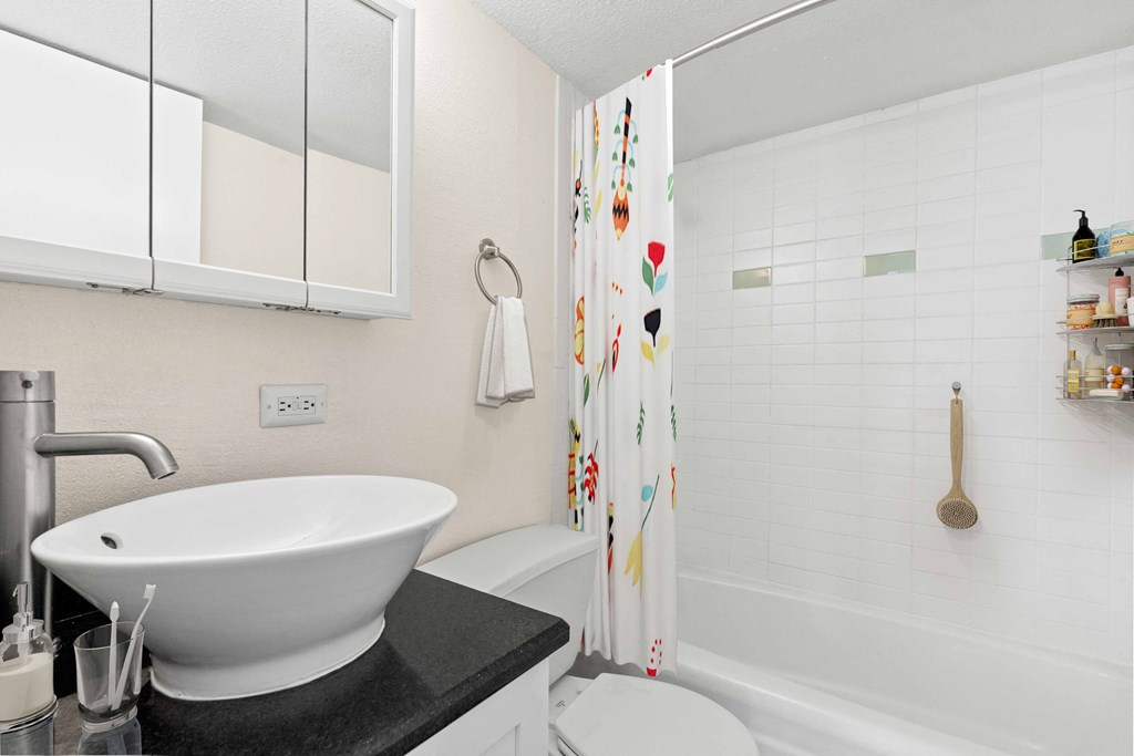 a bathroom with a sink and a tub and a shower curtain