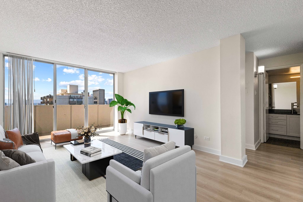 a living room with white furniture and a large window