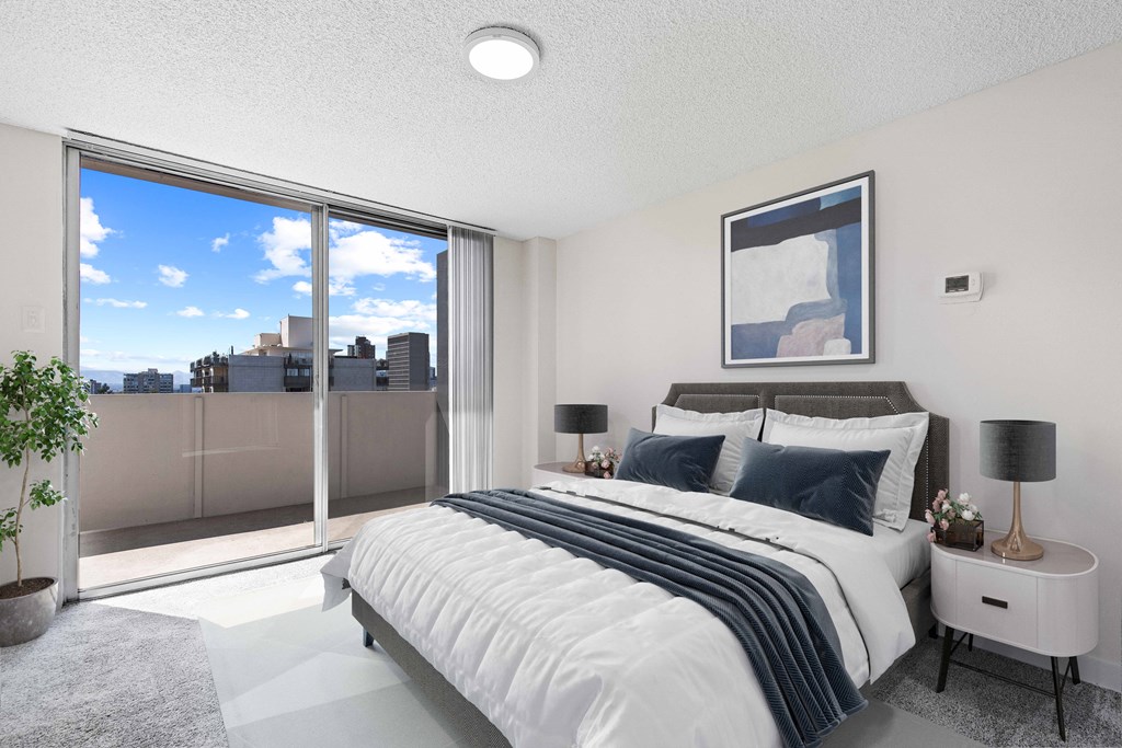 a bedroom with a bed and a large window