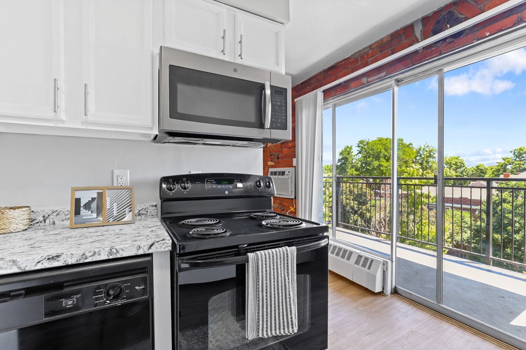 a kitchen with a stove top oven next to a window