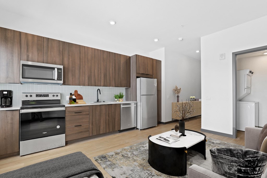 a kitchen with wooden cabinets and stainless steel appliances