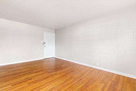 A room with wooden floors and a white door.