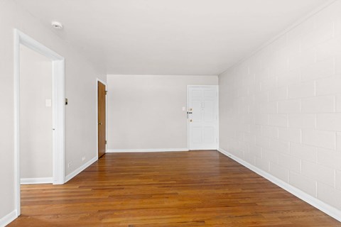 A room with wooden floors and white walls.