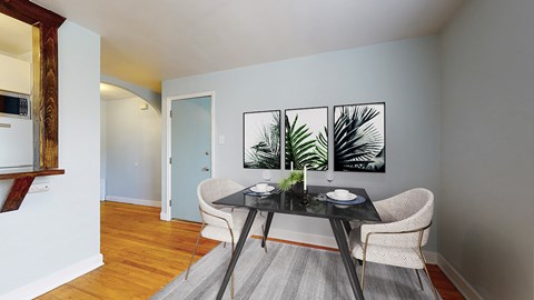 A dining room with a table and chairs.