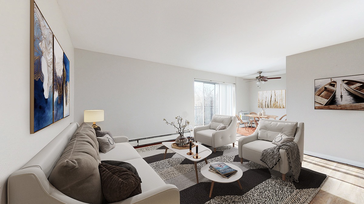 A living room with a grey couch, a coffee table, and a painting on the wall.