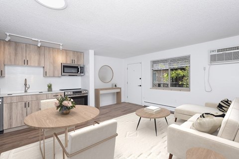 A modern living room with a dining table and chairs.