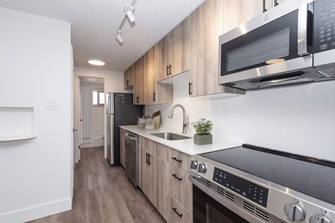 A kitchen with a stove top oven and a microwave.