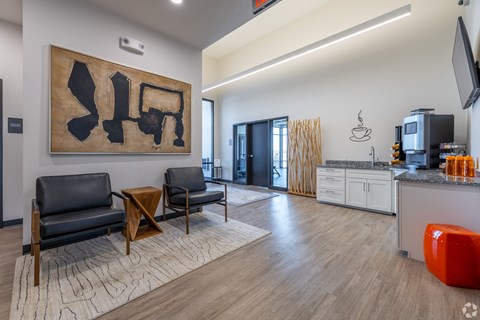 A modern living room with a large abstract painting on the wall.
