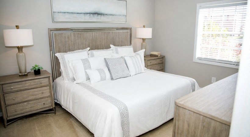 a bedroom with a large bed and two lamps