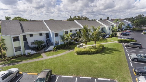 A parking lot with cars and a building in the background.