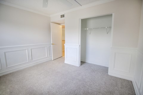 A room with a carpeted floor and a white door.