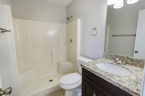 A white toilet sits next to a sink in a bathroom.