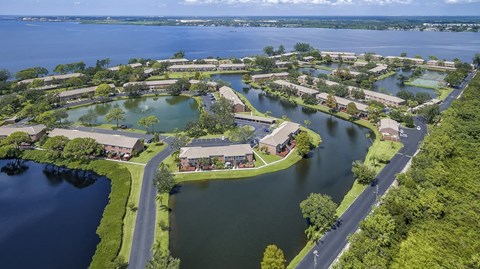 an aerial view of a neighborhood with a body of water