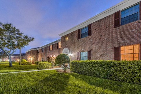 an exterior view of a brick building at night