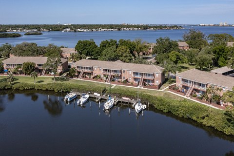 an aerial view of the resort with boats docked on the water