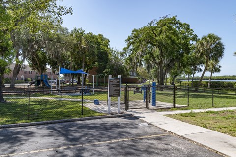 a park with a playground and a fence