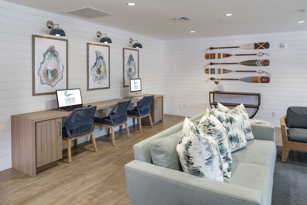 a living room with a couch and chairs and a table with surfboards