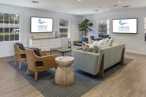 a living room with couches and chairs and a table