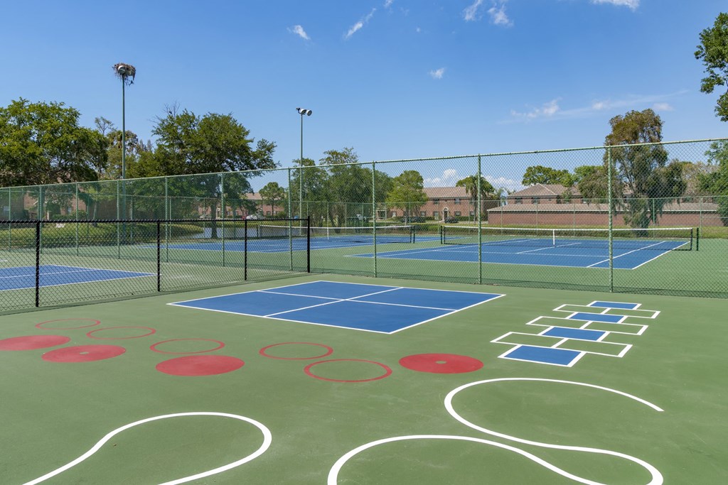 a tennis court with logos on it on a sunny day