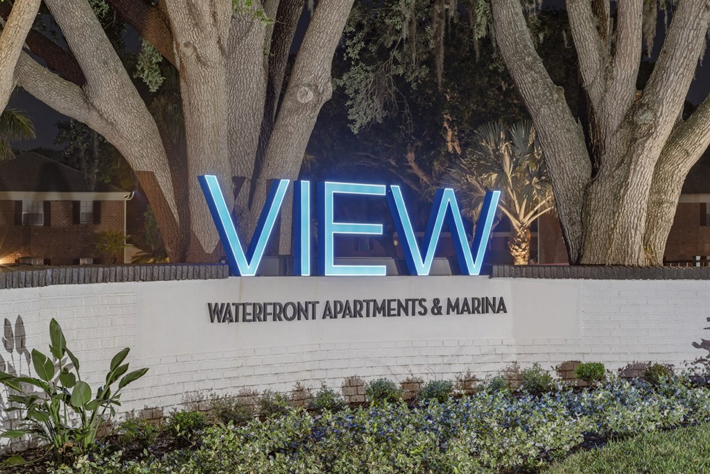 the view sign at the entrance to the water front apartments and marina