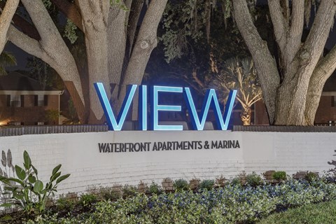 the view sign at the entrance to the water front apartments and marina