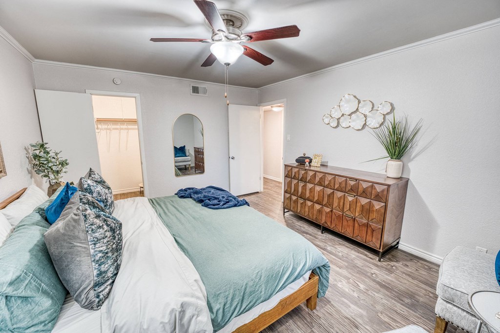 a bedroom with a bed and a ceiling fan