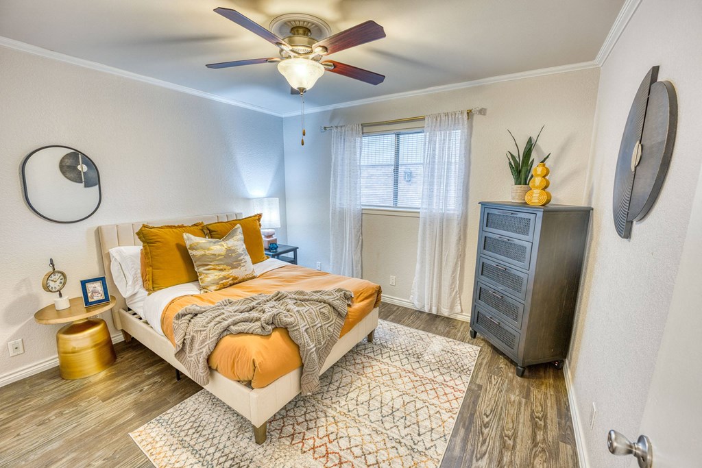 a bedroom with a bed and a ceiling fan