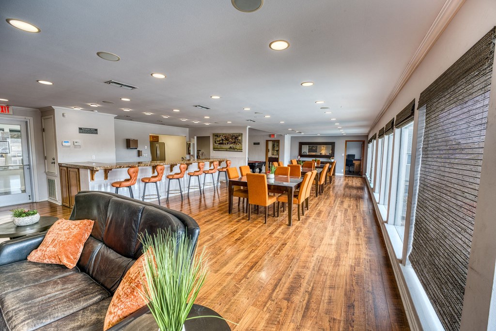 a living room with a table and chairs and a bar