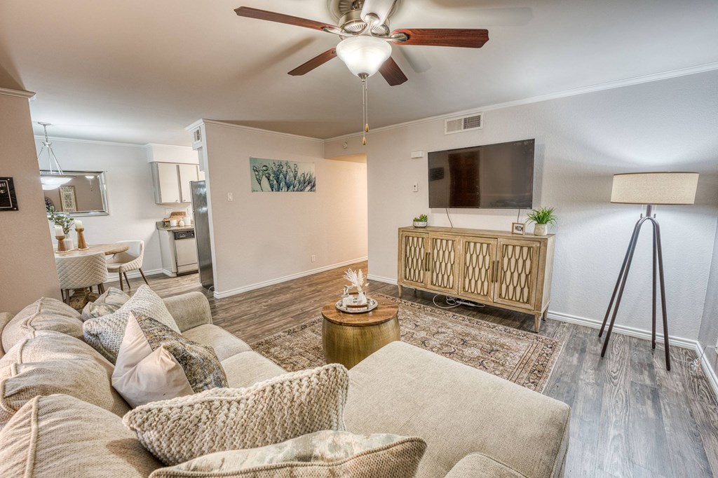 a living room with a couch and a ceiling fan