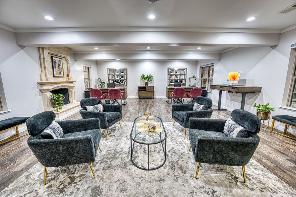 a living room with couches and chairs and a fireplace