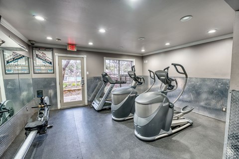 Fitness center with cardio equipment and floor mats at Le Montreaux Apartments, Austin, TX 78759