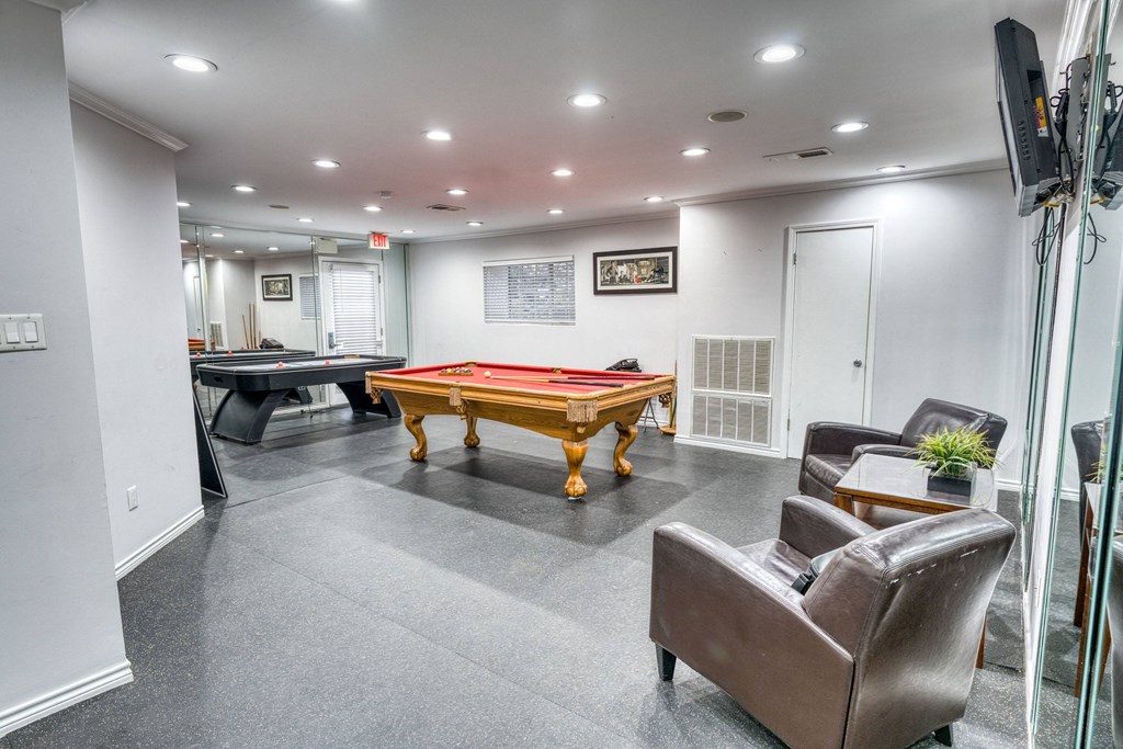 a games room with a pool table and ping pong