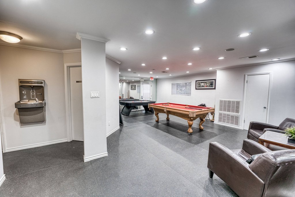 a game room with a pool table and a billiard table