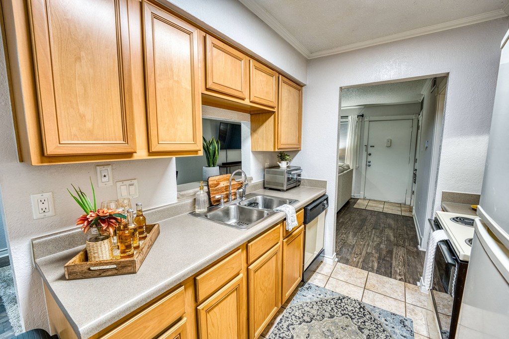 a kitchen with wooden cabinets and a sink