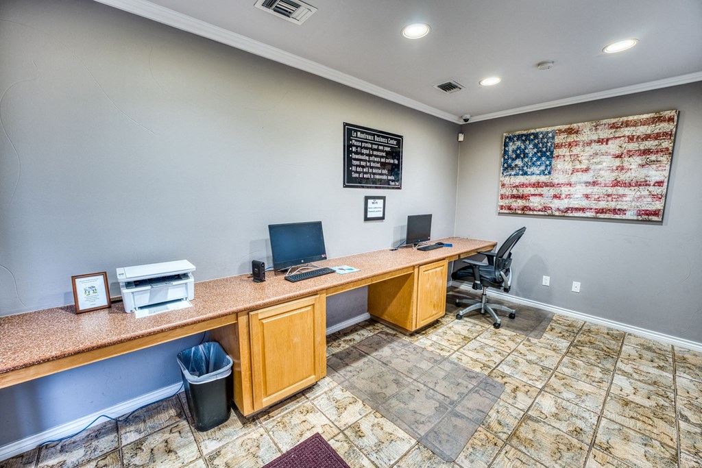 a home office with a long desk and two computers