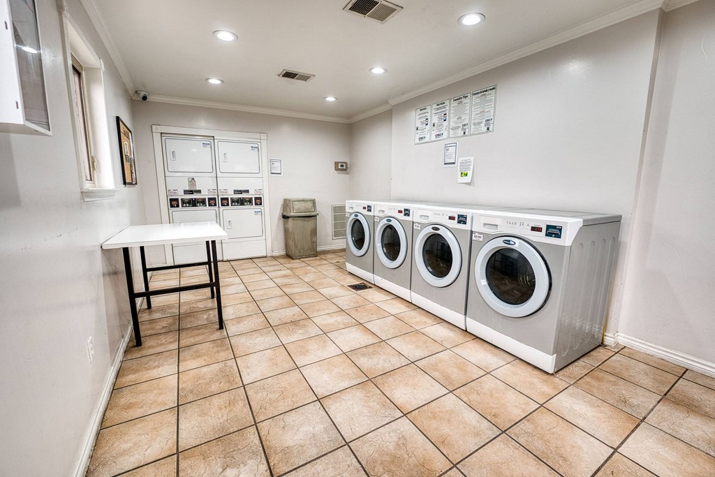a washer and dryer in a laundry room with a table