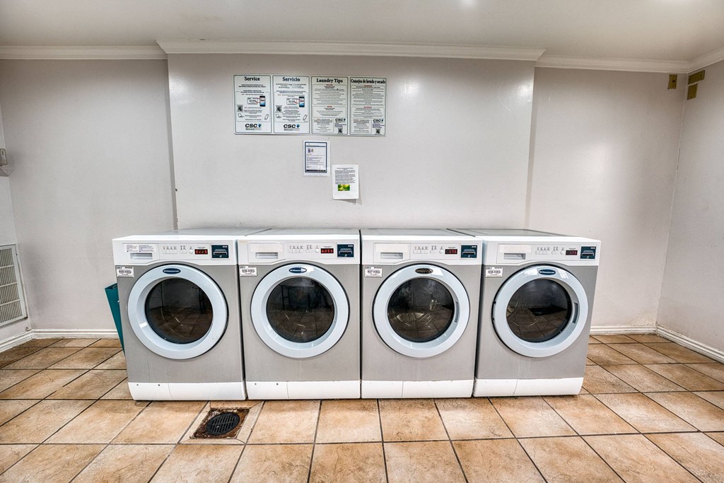 a laundry room with four washing machines in it