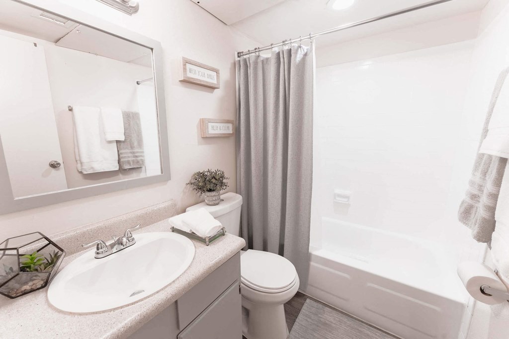 a bathroom with a sink toilet and shower  at Cantera Apartments, El Paso TX 79935