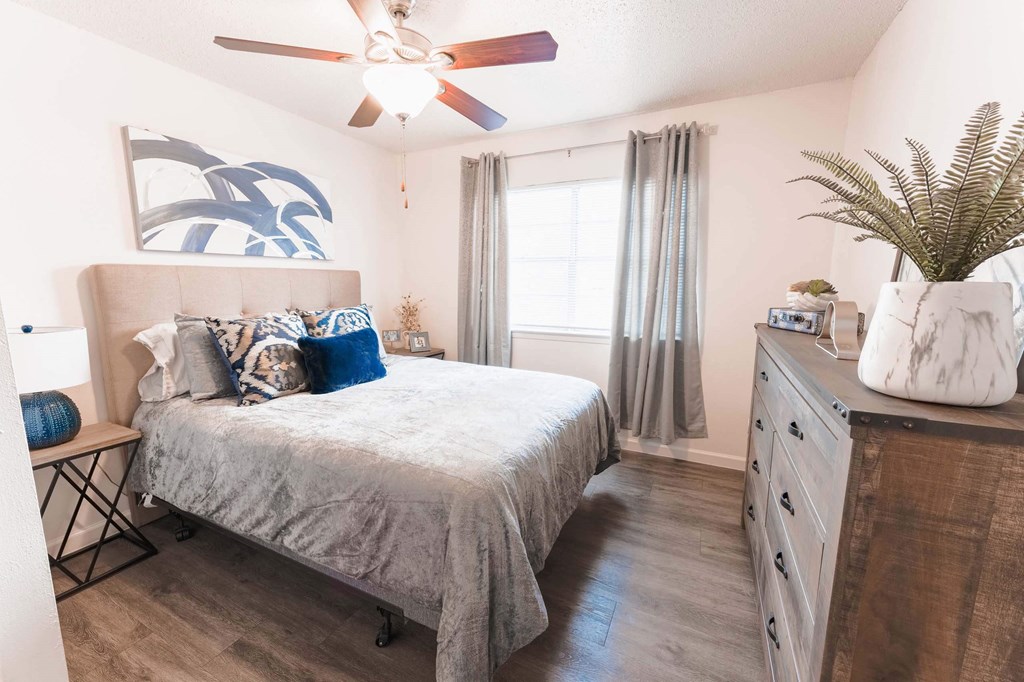a bedroom with a bed and a dresser  at Cantera Apartments, El Paso TX 79935