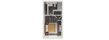 A small room with a bed, a desk, and a chair.