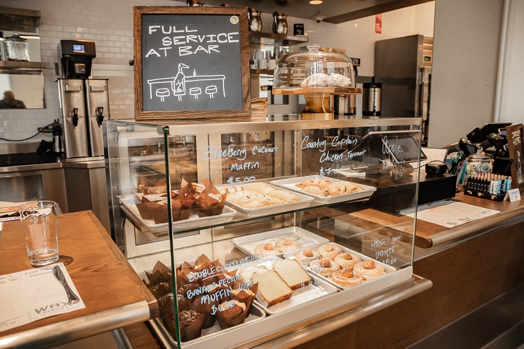 a display case filled with cakes and pastries in a bakery