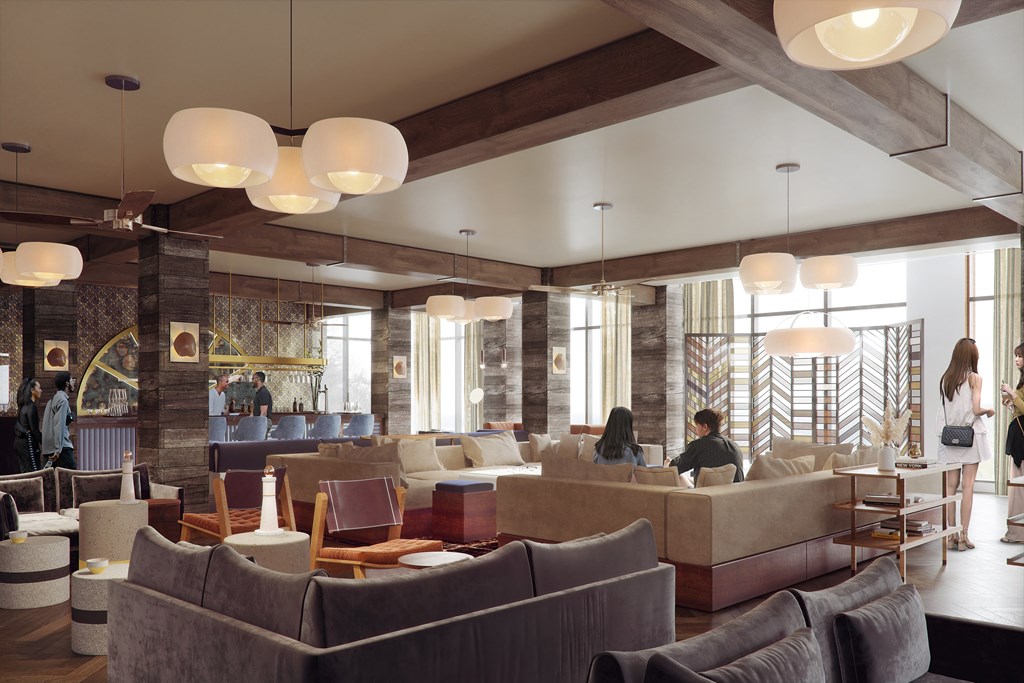 the lobby of a hotel with couches and tables