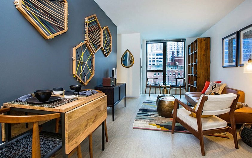 a living room with a table and chairs and a window