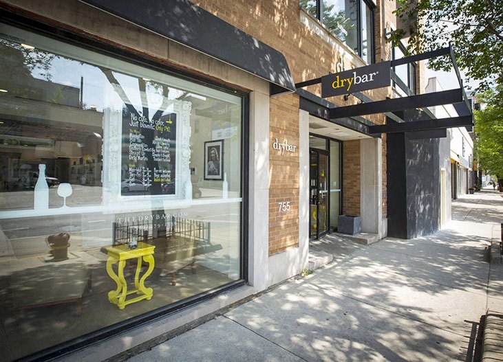 a store front with a yellow fire hydrant in the window