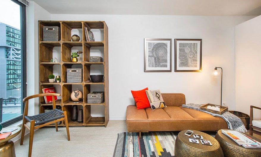 a living room with a couch and a shelf