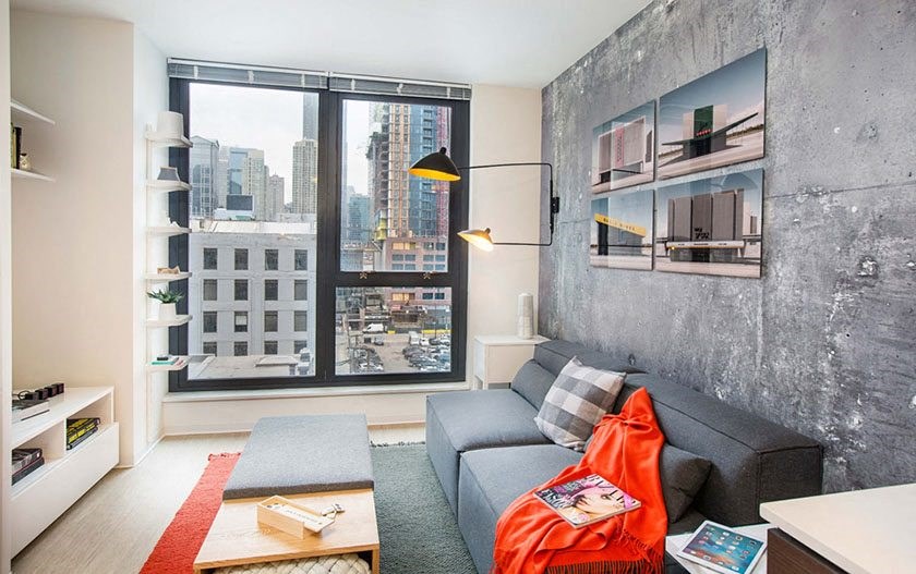 a living room with a gray couch and a large window