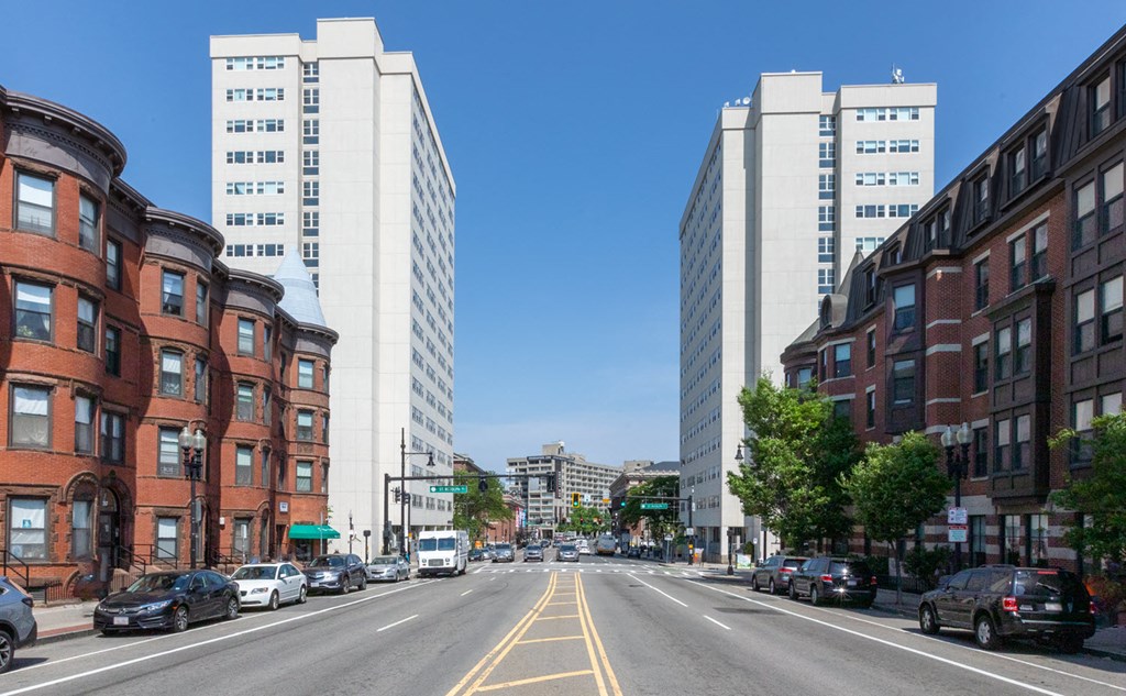 a view of a street in a city with tall buildings