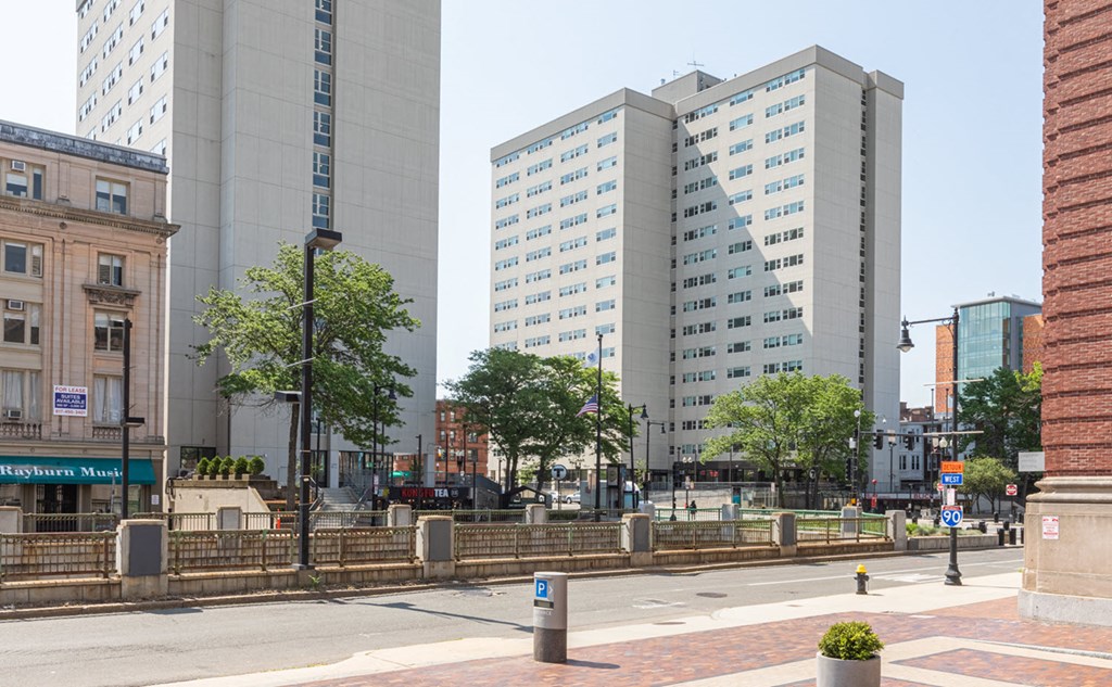 a view of two tall buildings on a city street