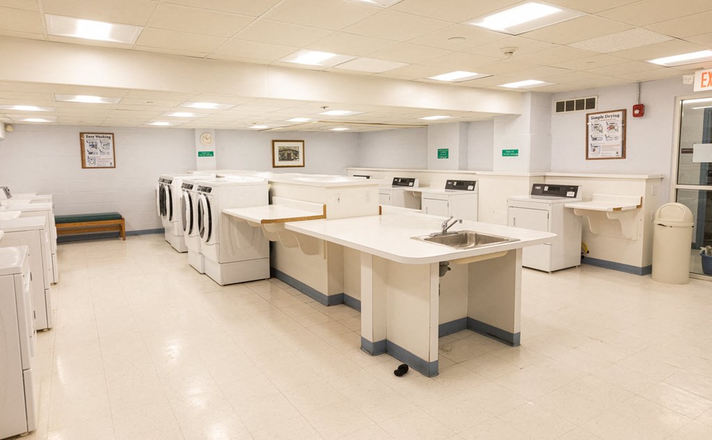 a laundry room with several sinks and machines in it